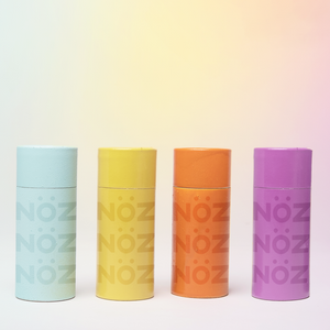 Front view of four nöz sunscreen bottles in a variety of colors. 